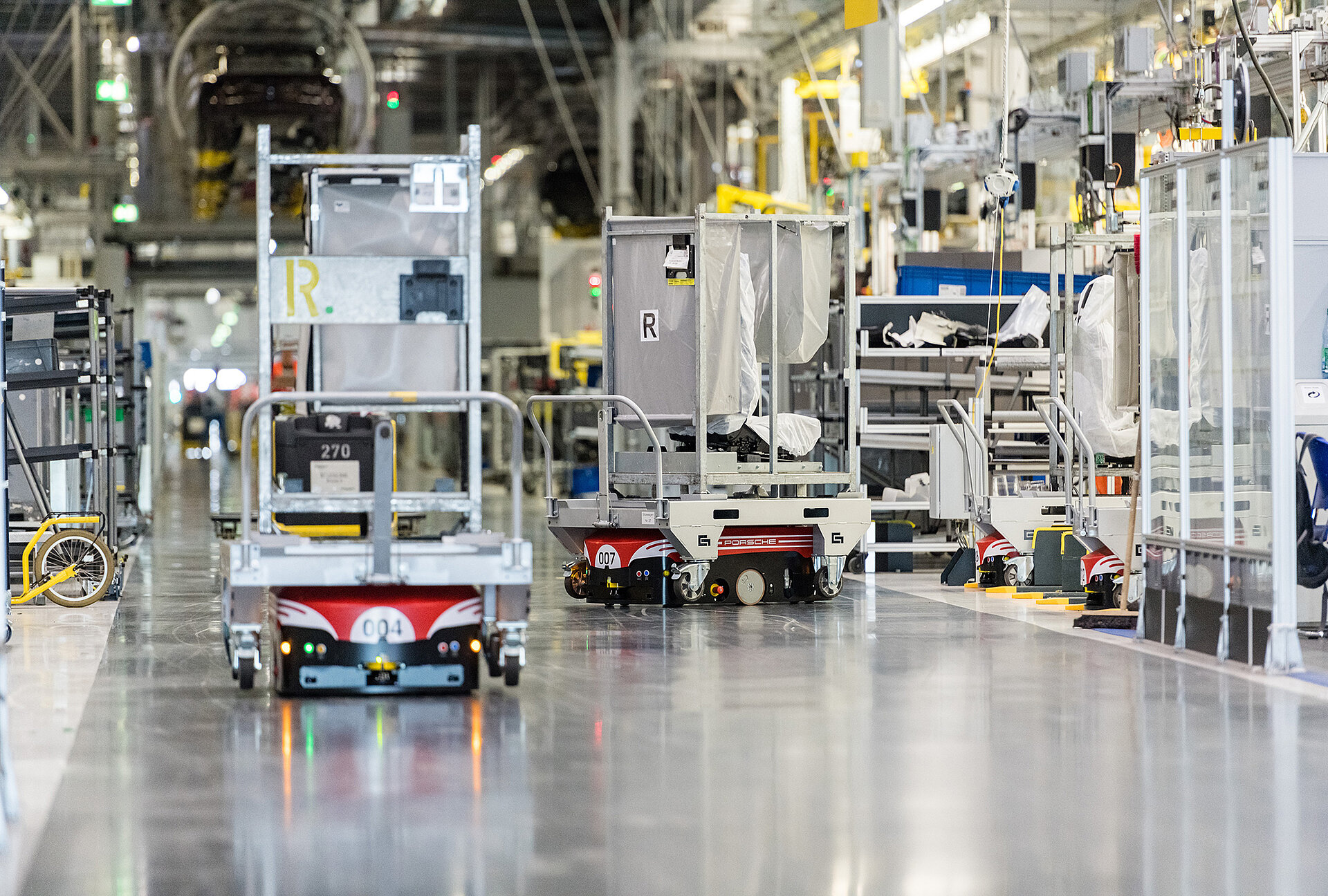 Automated guided vehicles with goods carriers in use